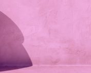 Soft shadow on a pink-lilac surface. A visual metaphor for the contour of shadows and the depth it suggests.