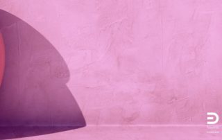 Soft shadow on a pink-lilac surface. A visual metaphor for the contour of shadows and the depth it suggests.